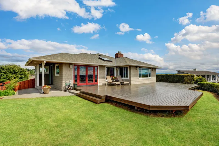 Sturdy and aesthetically pleasing deck stairs securely connecting an elevated outdoor deck to the backyard space.
