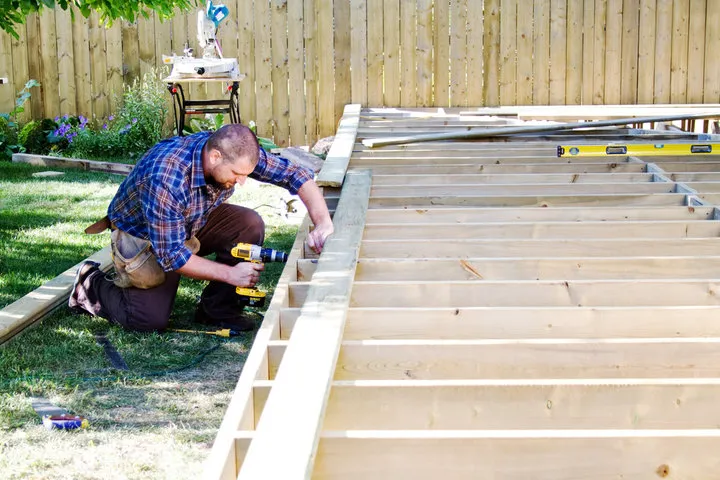 TUFF Deck Builders Toledo contractor collaboratively reviewing custom deck plans with a homeowner.